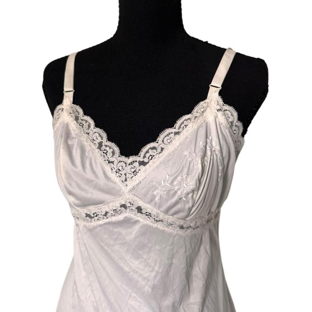 White lace slip dress with floral embroidery and adjustable straps